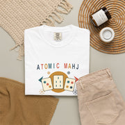 Folded ivory Atomic Mahj Comfort Colors shirt showing the retro Mahjong tile print in a styled product view.